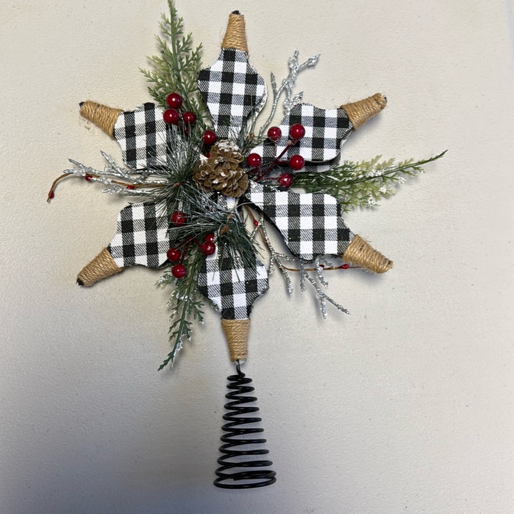 Christmas tree topper with pine sprigs and red berries